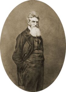 John Brown with hands in pockets, facing the camera.